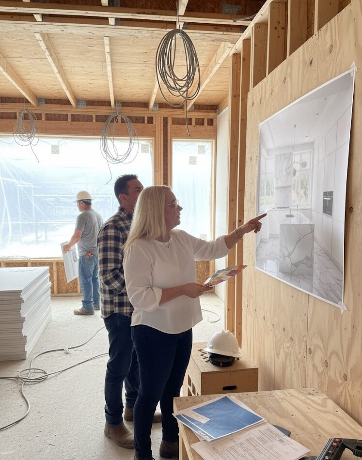 Consultant pointing to detailed construction plans and documents